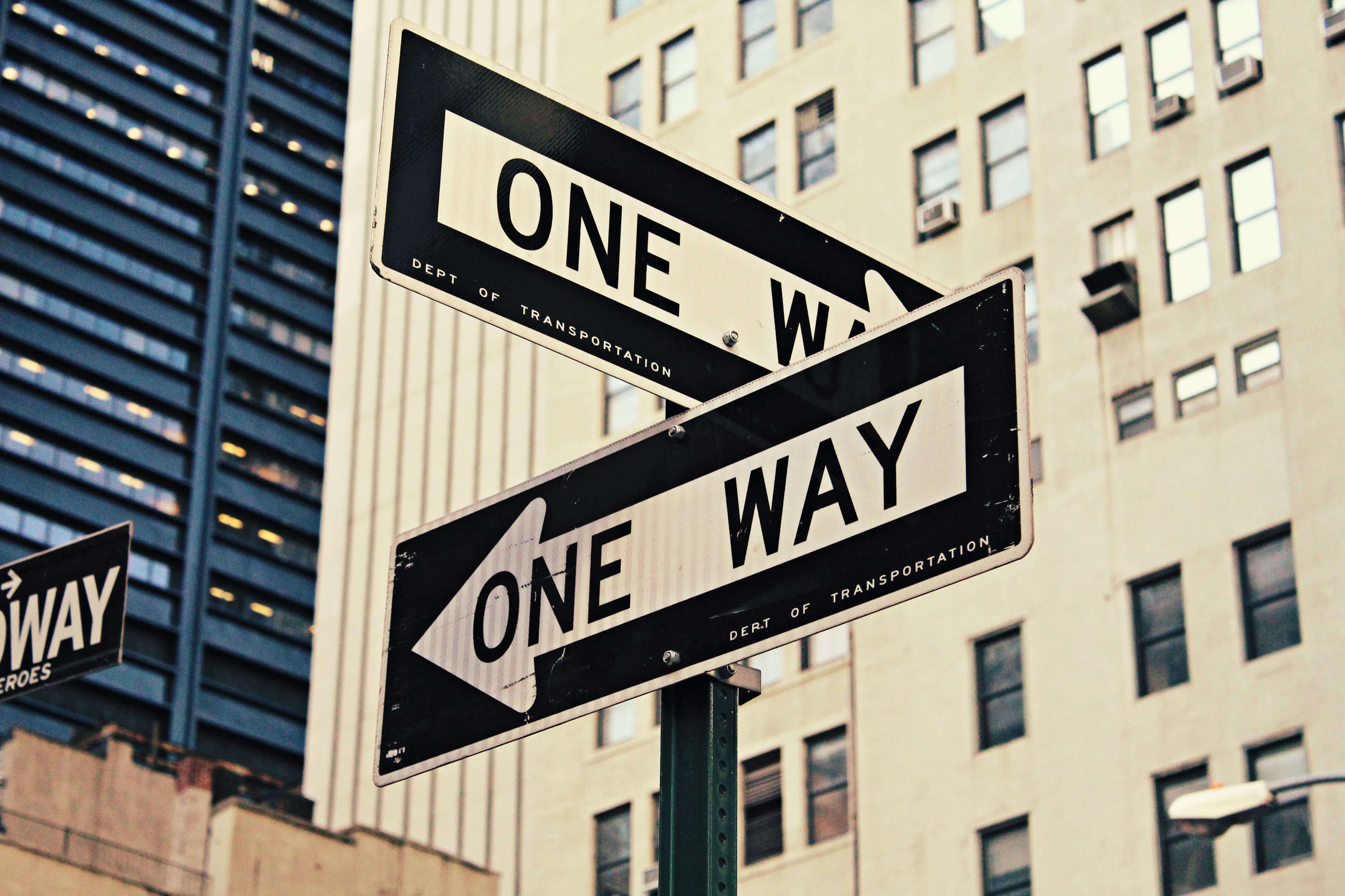 Photo of street signs reading 'ONE WAY'